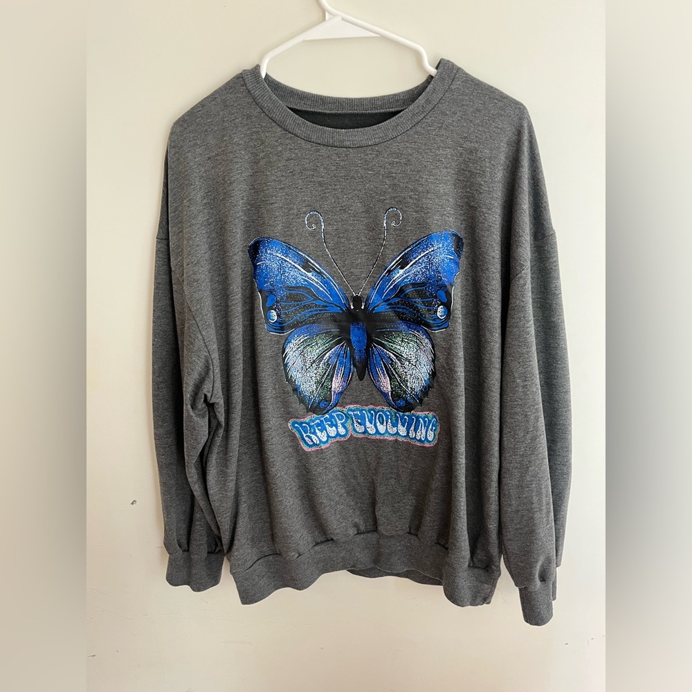A long sleeve shirt from SHEIN with a butterfly Lettering says keep evolving.